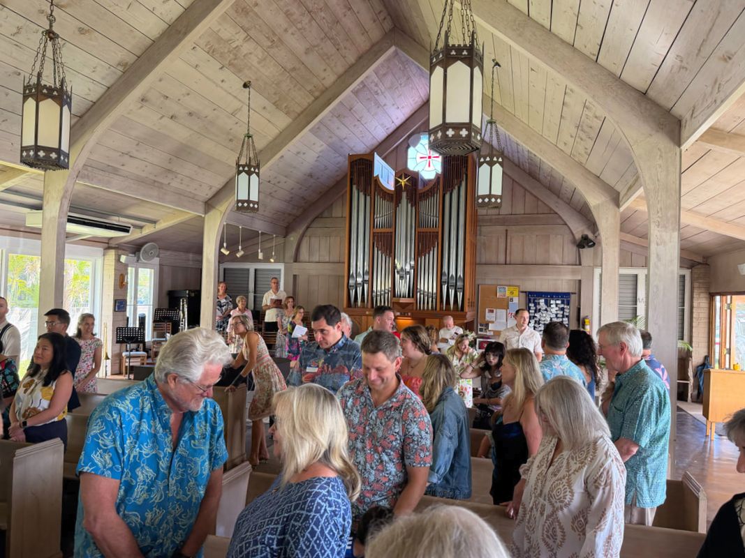 Parishioners of St. Christopher's greeting one another after Sunday service in the Kailua sanctuary